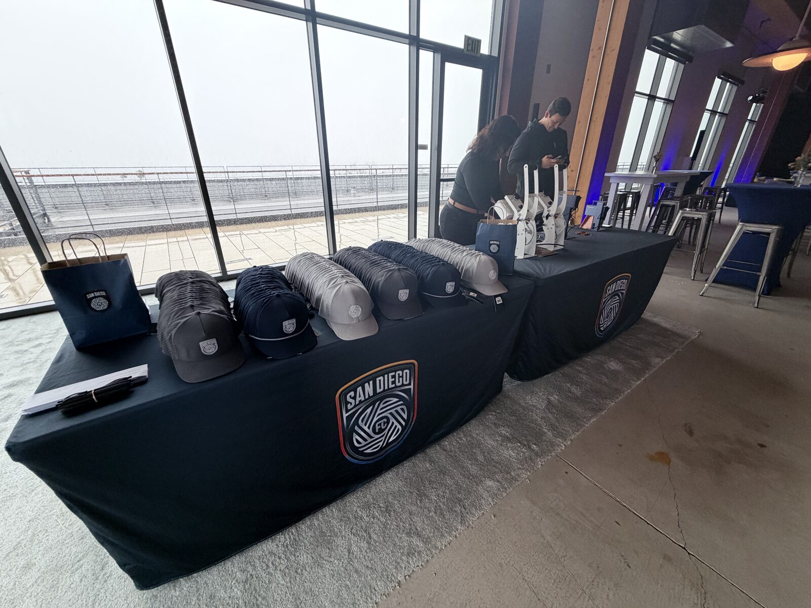 A row of heat-press stations set up beside the windows at a Las Vegas venue
