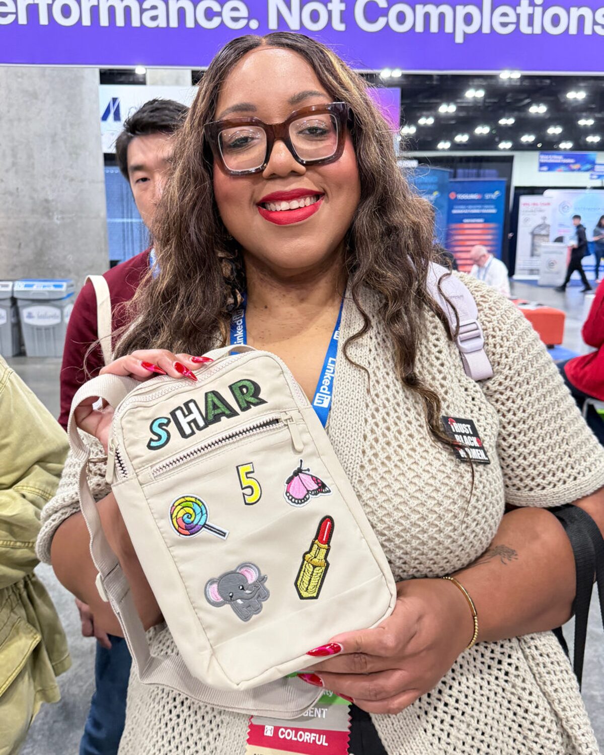 A guest holding a custom patch bag personalized at a live party station