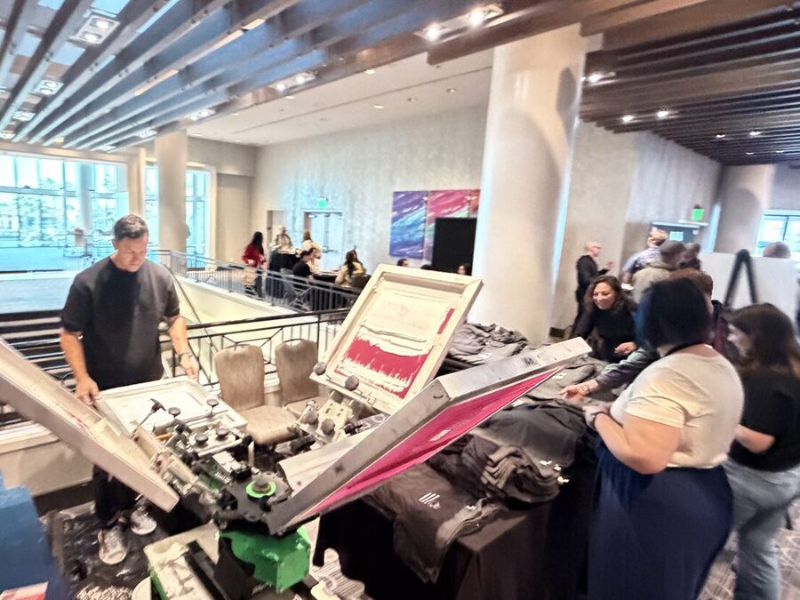 A close view of an automatic screen-print press head running at an event